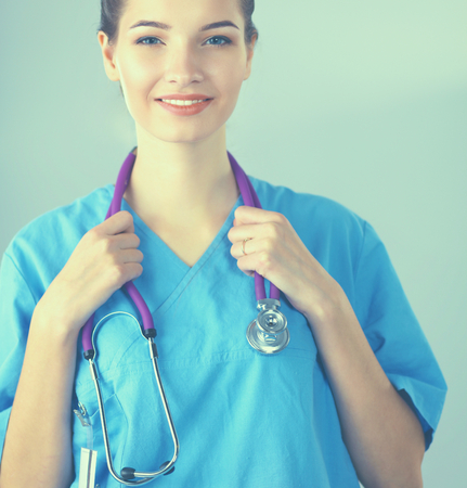 Smiling female doctor in uniform standing at hospitalの写真素材