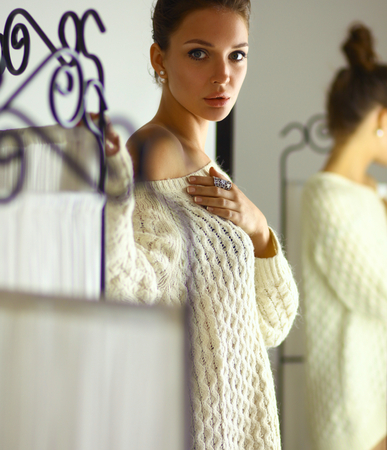 Portrait of a cute woman in sweater at homeの写真素材