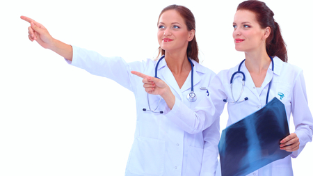 Portrait of two successful female doctors holding a writing pad and x-rayの写真素材