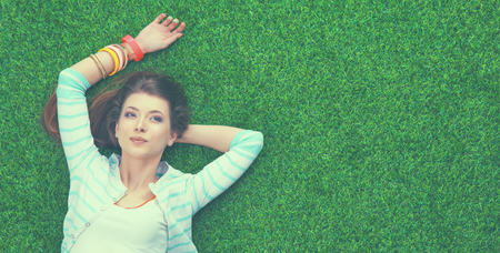 Top view of beautiful young woman holding hands behind headの写真素材