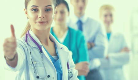 Attractive female doctor in front of medical groupの写真素材