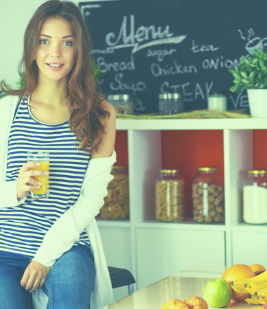 Portrait of a pretty woman holding glass with tasty juiceの写真素材