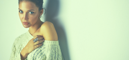 Portrait of a cute woman in sweater at homeの写真素材