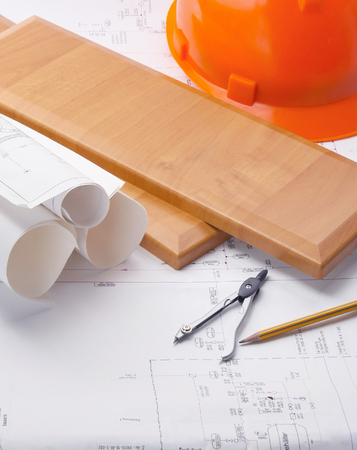orange hardhat with a ruler on wooden planksの写真素材