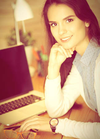 Young female working sitting at a deskの写真素材
