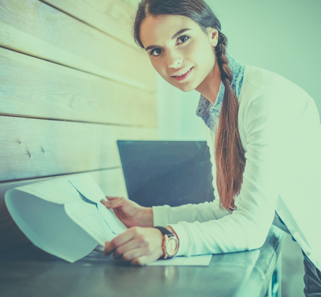 Young female standing near deskの写真素材