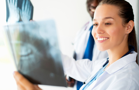 Female doctor looking at the x ray pictureの写真素材