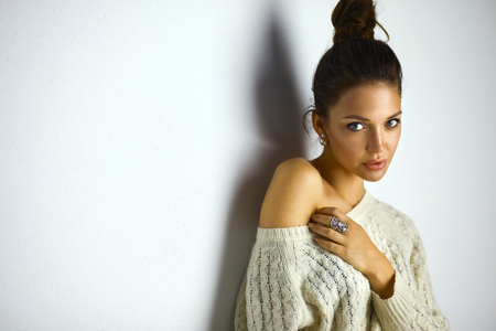 Portrait of a cute woman in sweater at homeの写真素材