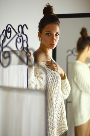Portrait of a cute woman in sweater at homeの写真素材