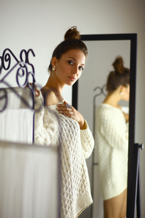 Portrait of a cute woman in sweater at homeの写真素材