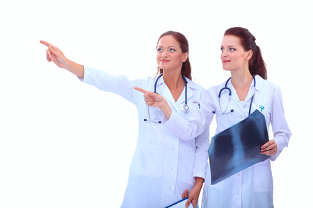 Portrait of two successful female doctors holding a writing pad and x-rayの写真素材