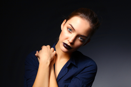 Portrait of beautiful young woman face. Isolated on black backgroundの写真素材