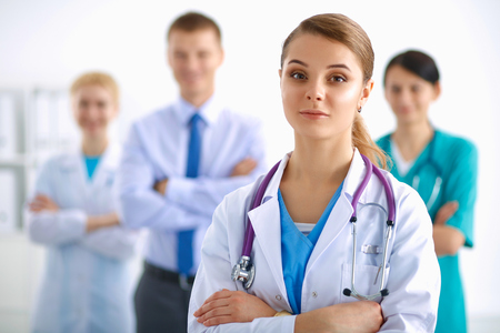Attractive female doctor in front of medical groupの写真素材