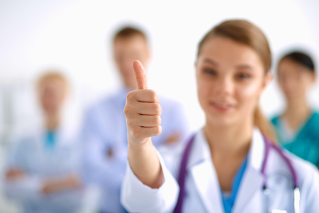 Attractive female doctor in front of medical groupの写真素材