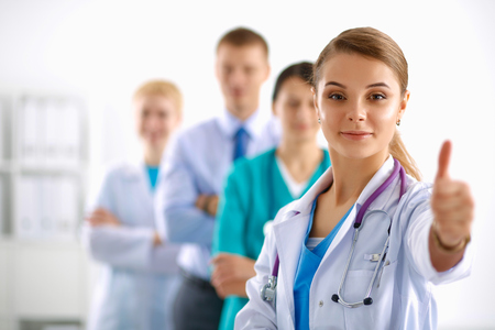 Attractive female doctor in front of medical groupの写真素材