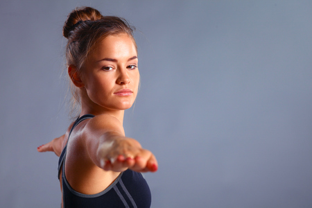 Portrait of sport girl doing yoga stretching exerciseの写真素材
