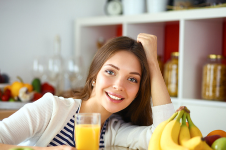 Portrait of a pretty woman holding glass with tasty juiceの写真素材