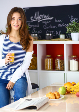 Portrait of a pretty woman holding glass with tasty juiceの写真素材