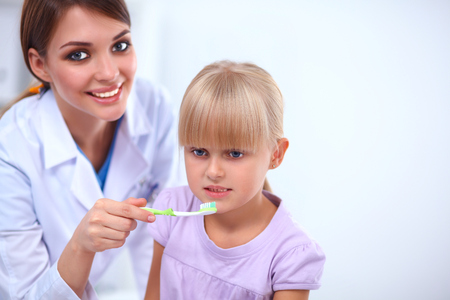 Dentist and little girl in the dentist officeの写真素材