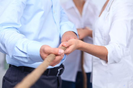 Concept image of business team using a rope as an element the teamwork on foregroundの写真素材