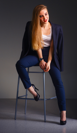 Young woman sitting on a chairの写真素材