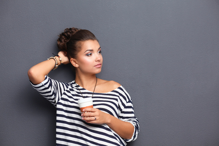 Portrait of young woman with cup tea or coffeeの写真素材