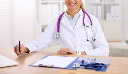 Medical team sitting at the table in modern hospitalの写真素材