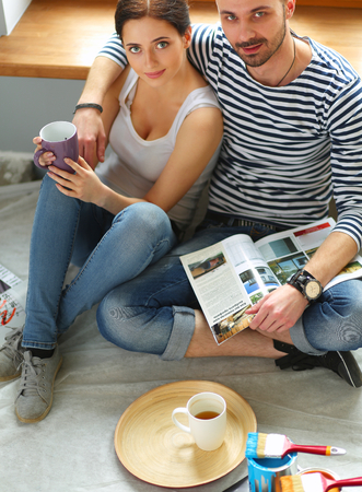 Couple moving in house sitting on the floorの写真素材