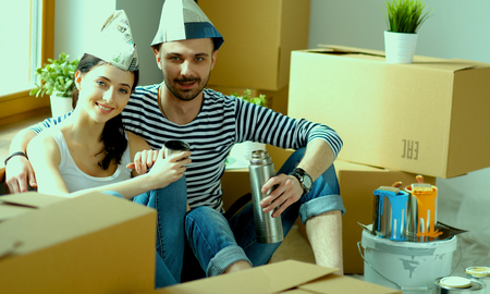 Portrait of young couple moving in new homeの写真素材