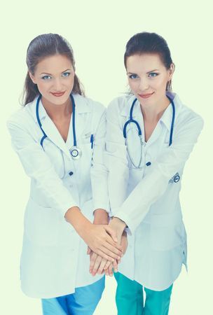 Doctors and nurses stacking hands. Isolated on white backgroundの写真素材