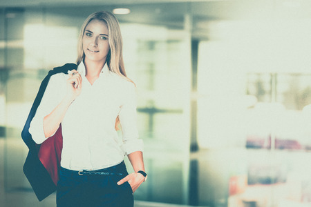 Young business woman standing in business centerの写真素材