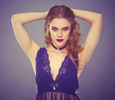 Close up portrait of beautiful young woman face. Isolated on gray background.の写真素材