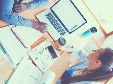 Business woman sitting in her office using a tablet computerの写真素材