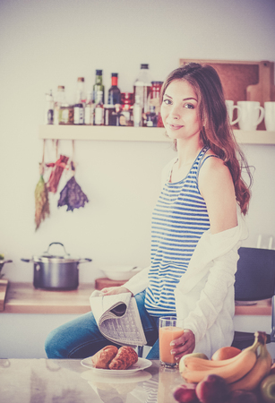 Portrait of a pretty woman holding glass with tasty juiceの写真素材