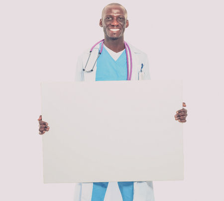 Male doctor holding empty placard.の写真素材