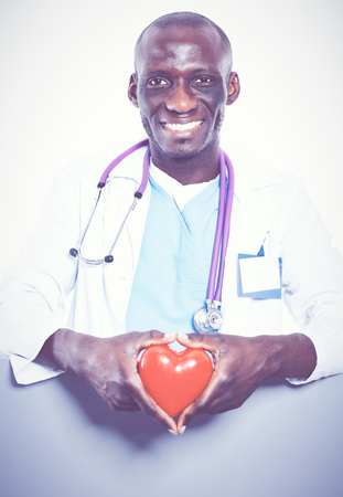 Male doctor with red heart and blank sign isolated on white backgroundの写真素材