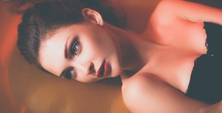 Portrait of beautiful girl with trendy makeup lyingの写真素材