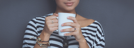 Portrait of  young woman with cup  tea or coffeeの写真素材