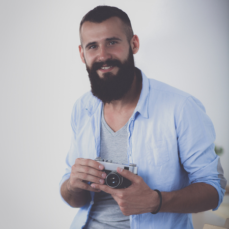 Portrait of male designer sitting on a table with blueprints.の写真素材