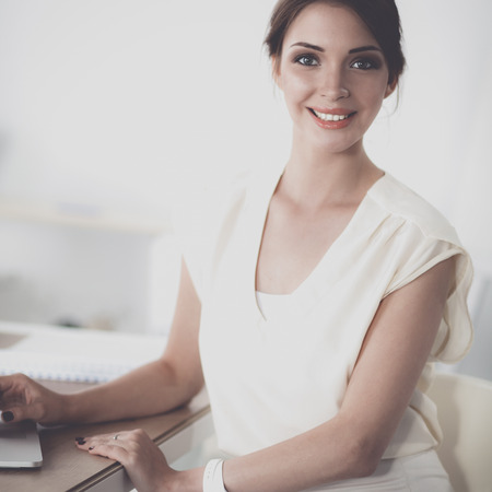Portrait of a businesswoman sitting at  desk with  laptopの写真素材