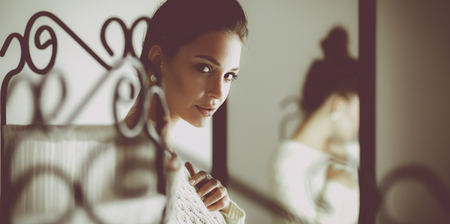 Portrait of a cute woman in sweater at homeの写真素材