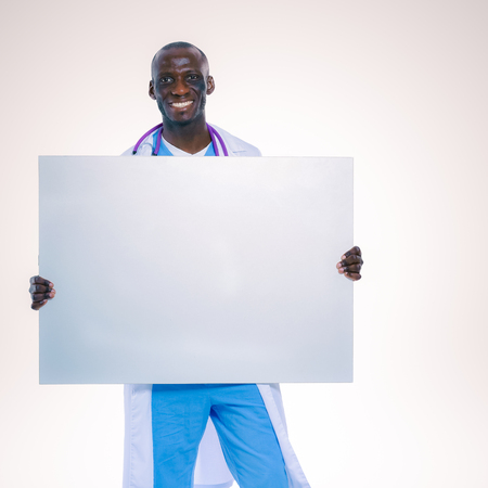 Male doctor holding empty placard, isolated on white backgroundの写真素材