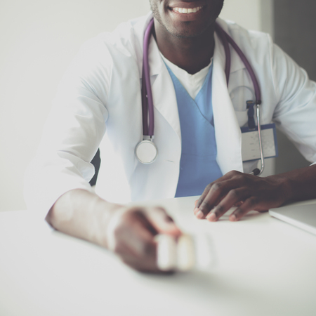 Close-up of male doctor giving jar of pills to patientの写真素材