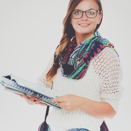 Portrait of a young student woman holding exercise books.の写真素材