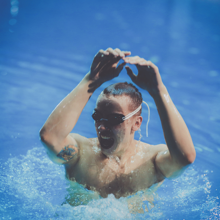 Male swimmer at the swimming pool. Underwater photoの写真素材