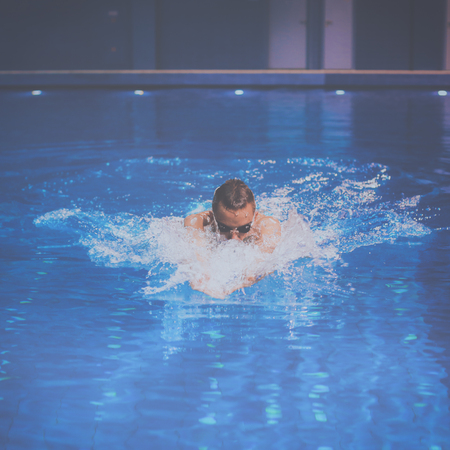 Male swimmer at the swimming pool. Underwater photoの写真素材