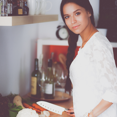 Young woman using a tablet computer to cook in her kitchenの写真素材