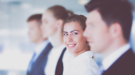 Smiling successful business team standing in officeの写真素材