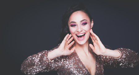 Beautiful young woman in evening dress on black backgroundの写真素材