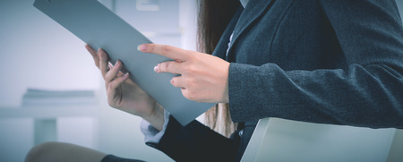Attractive businesswoman sitting in the officeの写真素材